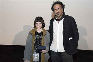 Stephanie Delazari (The Horror, In the Home) accepts her award from Alejandro Iñárritu.